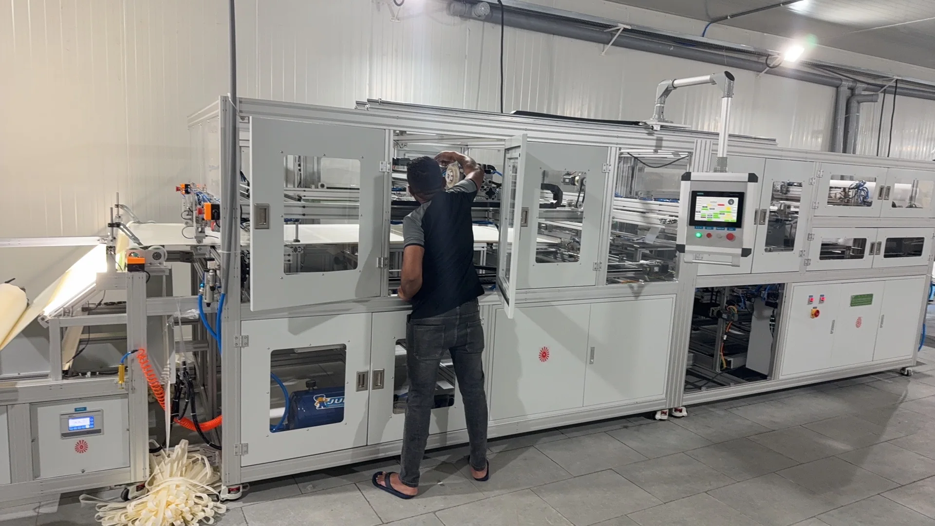 Operator working beside RO membrane production equipment at Payas in India